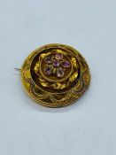 A Gold Brooch with semi precious stones