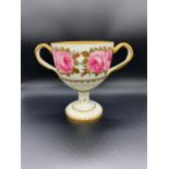 A Cauldon Ltd, two handled chalice style cup. Hand painted with a rose theme. (H18cm)