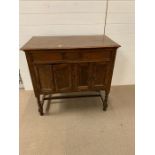 A mahogany cabinet on barley twist legs housing a gramophone (H89cm W92cm D51cm)