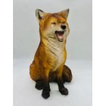 A resin decorative fox standing approx. 33cm tall