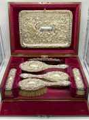 A Walker & Hall silver dressing table set, hallmarked Sheffield 1911, with seven pieces in velvet