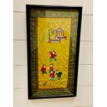 A framed needlework silk of oriental theme