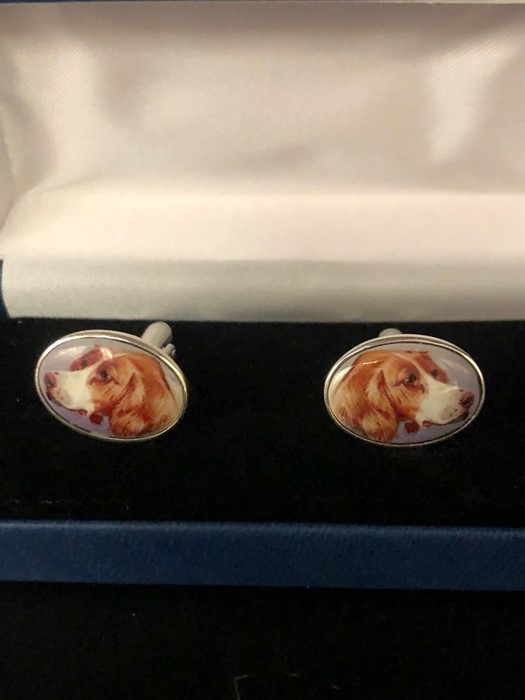 A Pair of silver and enamel cuff links depicting a dog, cased.