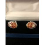 A Pair of silver and enamel cuff links depicting a dog, cased.