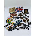 A selection of militaria insignia and reproduction WW1 Germany badges and cloth badges.