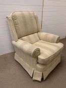 An upright easy arm chair in soft furnishings