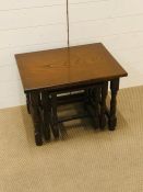 A nest of three dark oak cottage style tables