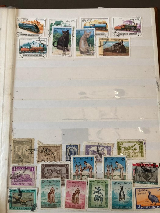 A stamp album containing amongst others stamps from Ajman, Fujeira, Persanes and Iran.