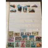 A stamp album containing amongst others stamps from Ajman, Fujeira, Persanes and Iran.