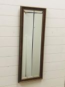 A contemporary bevelled hall mirror in walnut and gold effect frame (100cm x 40cm)