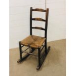 An oak rocking chair with rush seat AF