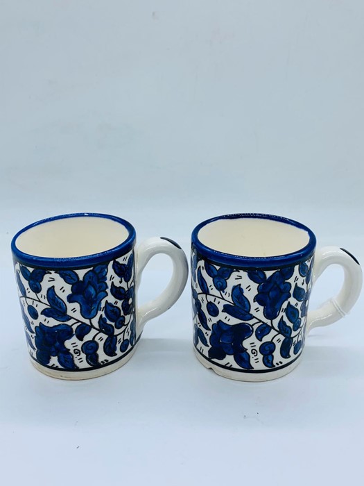 A pair of decorative blue and white coffee cans