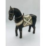 A decorative wooden horse featuring brass, white metal and shell decoration