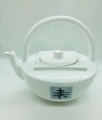 A large white china teapot with Chinese symbol