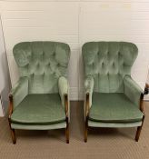 A pair of button back fireside chairs in green upholstery by Hypnos