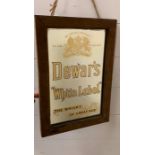 A Dewars 'White Label' mirror by Warrant to H.M The King.