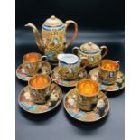 A Japanese hand painted tea set to include tea pot, milk jug, sugar bowl with lid, five saucers