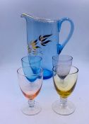 A coloured vintage jug and four glasses