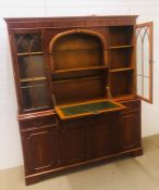 A large yew effect drinks display cabinet with internal lighting and original key