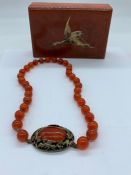 An Oriental Amber Necklace in Box