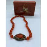 An Oriental Amber Necklace in Box