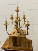 A brass chandelier converted into a table lamp