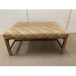 An ottoman with fabric covering and wooden frame.(H 45cm x 102cm L x 72cm D)