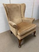 Parker Knoll wing back chair in gold fabric (H97cm)