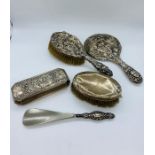 A selection of four silver backed dressing table items.