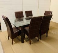 A glass top dining table with six high back leather chairs (H75cm W180cm D100cm)