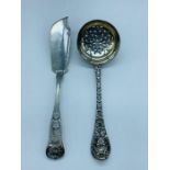 A silver sugar sifter and fish knife