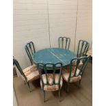 A shabby sheek circular table with six chairs