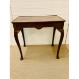 A mahogany side table with shallow gallery top