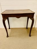 A mahogany side table with shallow gallery top