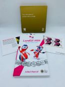 A London 2012 50 pence Sports Collection Set along with a 2012 Olympic Badge and Stamps