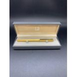 A Dunhill ink pen with 14ct gold nib.