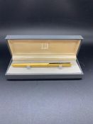 A Dunhill ink pen with 14ct gold nib.