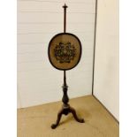 An mahogany pole screens in set with floral oval panels