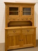 An oak dresser with glazed doors with cupboard under (H210cm W146cm D54cm)