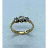 An 18 ct gold three diamond stone ring. (2.4g) Size N