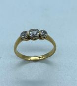 An 18 ct gold three diamond stone ring. (2.4g) Size N