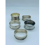 Five silver napkins rings various hallmarks and years