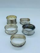 Five silver napkins rings various hallmarks and years