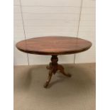 A mahogany breakfast table with inlay tilt top and tripod base H78cm x W 97cm x L 131cm