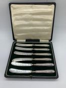 A Box of hallmarked silver butter knives.