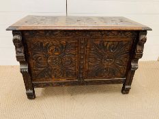 A two panel coffer with hinged lid with carved detailing to front and top (H60cm W80cm D46cm)
