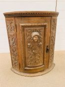 A Turn of the Century Flemish Bow Fronted Oak Corner Cabinet