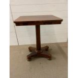 A rosewood library table with bun feet (H67cm W56cm D45cm)
