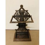 A cast iron stick stand and metal drip tray H69cm x D22cm x L40cm