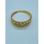 An 18 ct gold and five stone ring (3.4g) Size P